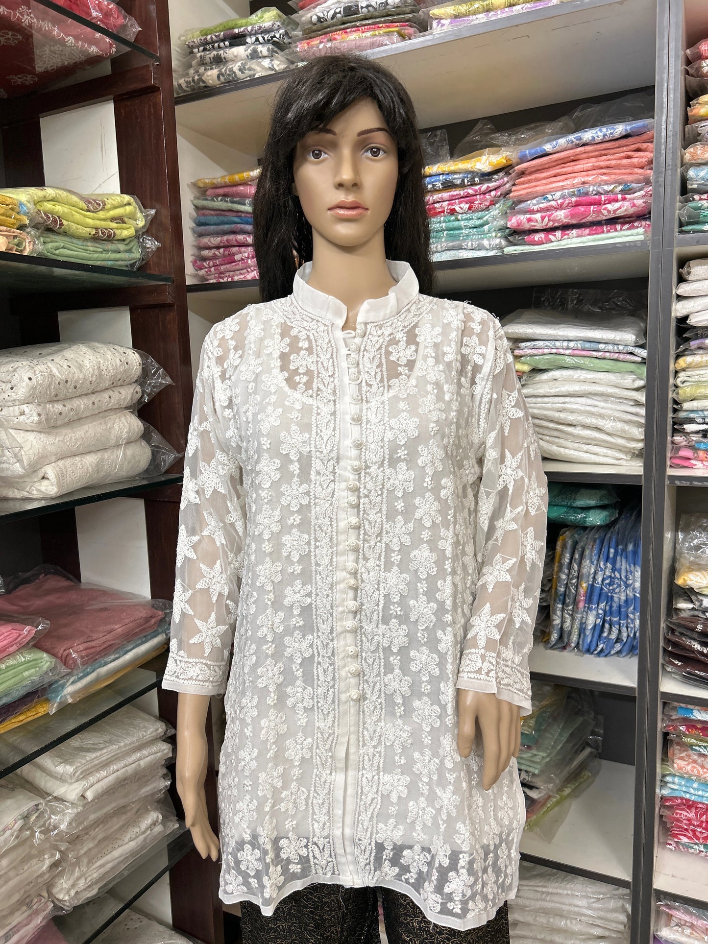Mannequin wearing a lucknowi chikankari white lace top in a fabric store