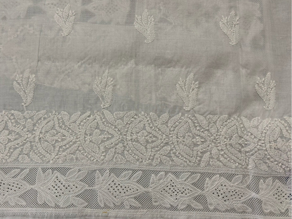 Embroidered fabric with intricate patterns on a gray background
