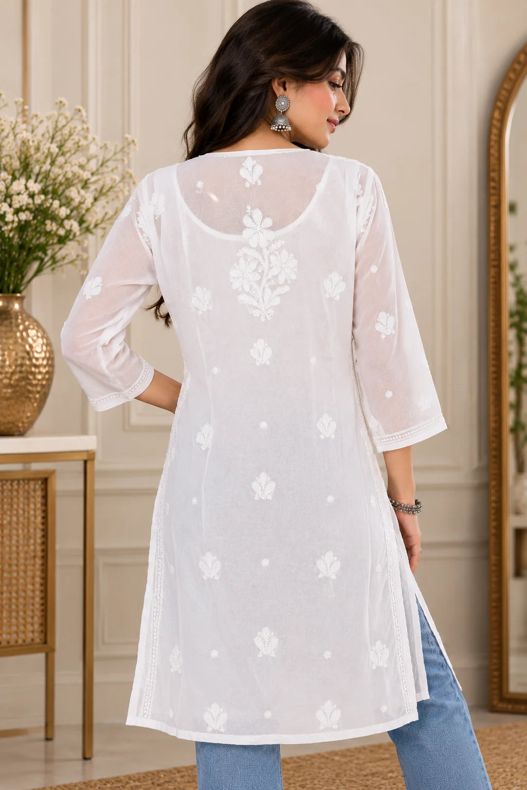 Woman wearing a lucknowi chikankari white-colored kurta with white floral patterns