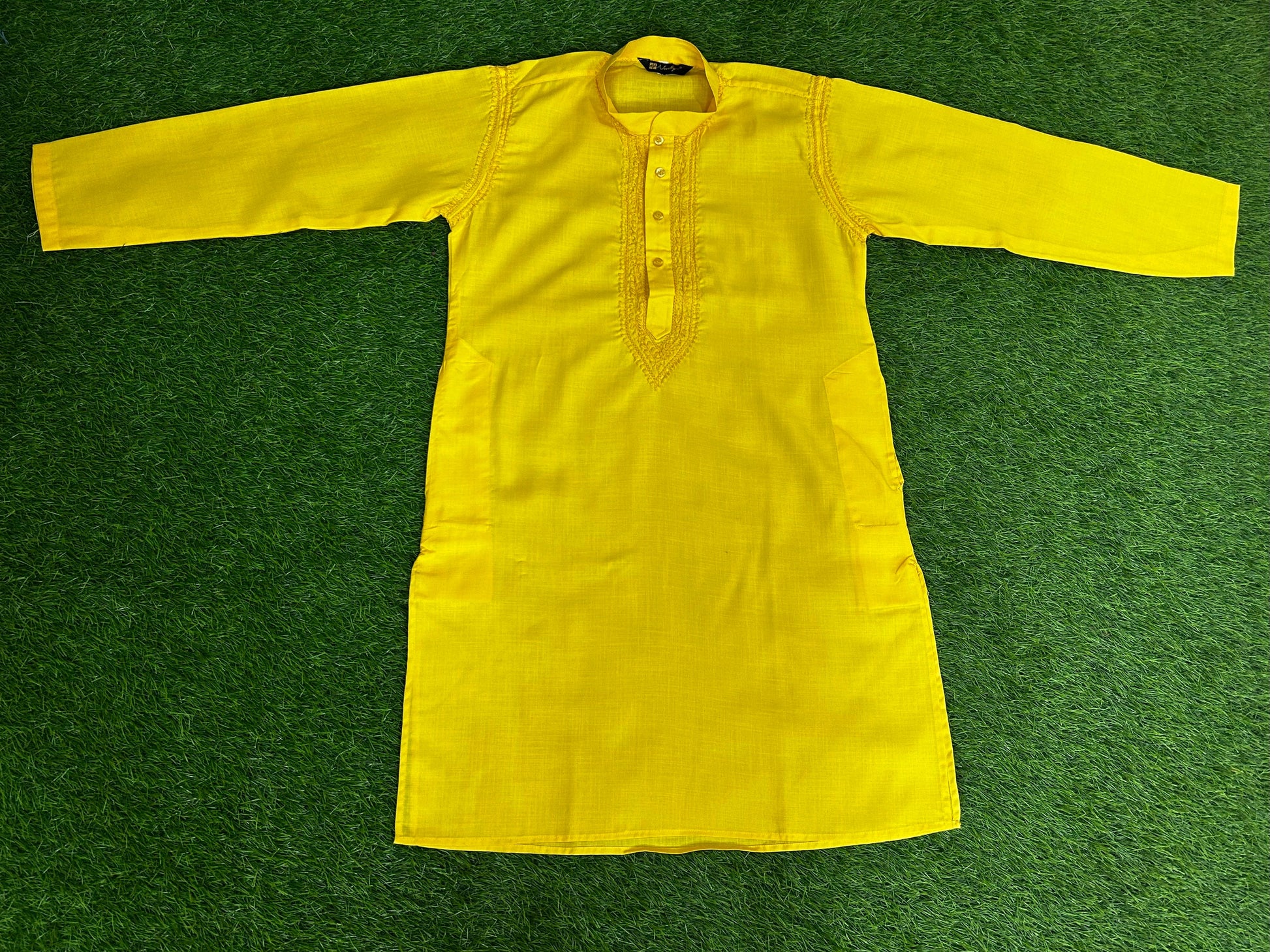 lucknowi chikankari Yellow jacket on a green grass background