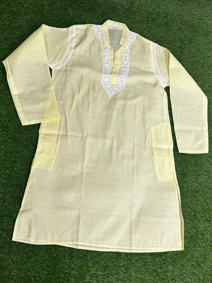 lucknowi chikankari Light-colored kurta with intricate detailing on a green background
