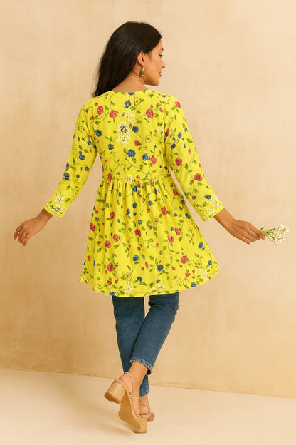 Woman wearing a lucknowi chikankari yellow floral dress against a beige background